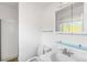 Compact bathroom with a toilet, vanity, and a shower behind a partial glass partition at 6953 Ingalls St, Arvada, CO 80003