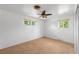 Neutral bedroom features carpet and two windows, providing plenty of natural light at 6953 Ingalls St, Arvada, CO 80003