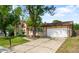 This inviting home features a two-car garage and a manicured lawn, enhancing its curb appeal at 6953 Ingalls St, Arvada, CO 80003