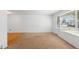 A bright living room featuring new carpet and a large window that floods the space with natural light at 6953 Ingalls St, Arvada, CO 80003