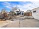 Spacious backyard with partial fencing and a concrete area, offering potential for various outdoor uses and landscaping at 1517 W Nevada Pl, Denver, CO 80223