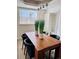 Modern dining room featuring a wooden table, black chairs, and contemporary lighting fixture at 1517 W Nevada Pl, Denver, CO 80223