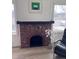 Close-up of brick fireplace with black mantel, adjacent to comfortable seating area at 1517 W Nevada Pl, Denver, CO 80223