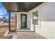 Inviting front door with brick-paved entryway and window, providing natural light and a welcoming entrance at 1517 W Nevada Pl, Denver, CO 80223