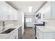 Modern kitchen featuring sleek white cabinets, stainless steel appliances, and stylish countertops at 1517 W Nevada Pl, Denver, CO 80223