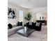 Inviting living room with chic black and white decor, and an adjacent dining area at 1517 W Nevada Pl, Denver, CO 80223