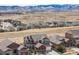 Panoramic aerial view of a community with mountain backdrop, showcasing modern homes at 17786 W 86Th Ln, Arvada, CO 80007