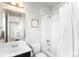 Clean bathroom with a shower-tub combo, white tiling, and a modern vanity at 17786 W 86Th Ln, Arvada, CO 80007