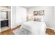 A bright bedroom features hardwood floors, closet, floral decor, and ensuite bathroom at 17786 W 86Th Ln, Arvada, CO 80007