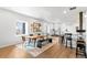 Open dining area with a long wooden table, bench seating, and a bar area at 17786 W 86Th Ln, Arvada, CO 80007