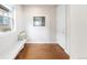 Bright entryway features beautiful hardwood floors, a bench, and a window with neighborhood views at 17786 W 86Th Ln, Arvada, CO 80007
