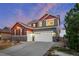 Charming two-story home featuring a three-car garage, stone accents, and appealing color palette at 17786 W 86Th Ln, Arvada, CO 80007