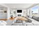 Spacious living area featuring a fireplace, large windows, and stylish decor at 17786 W 86Th Ln, Arvada, CO 80007