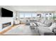 Bright and airy living room with large windows, fireplace, and comfortable seating at 17786 W 86Th Ln, Arvada, CO 80007