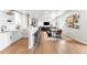 Open floor plan living space includes modern kitchen, bar, dining, and living room areas at 17786 W 86Th Ln, Arvada, CO 80007