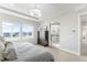 Bright main bedroom boasts large windows with neighborhood views and ensuite bathroom at 17786 W 86Th Ln, Arvada, CO 80007