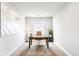 Bright home office featuring a large desk, comfortable chair, and ample natural light at 17786 W 86Th Ln, Arvada, CO 80007