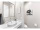 This stylish powder room features modern fixtures, decor, and a vessel sink on a vanity counter at 17786 W 86Th Ln, Arvada, CO 80007