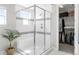 A clear glass shower features decorative tile accents, a bench seat, and a walk-in closet at 17786 W 86Th Ln, Arvada, CO 80007