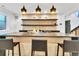 Finished basement bar area with a large countertop, sleek lighting, and open shelving for a modern entertainment space at 1100 S Gilpin St, Denver, CO 80210