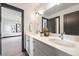 Bathroom featuring double vanity, modern finishes, and a glimpse into the main bedroom at 1100 S Gilpin St, Denver, CO 80210