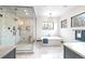 Luxurious bathroom featuring marble floors, glass shower, soaker tub, and modern design at 1100 S Gilpin St, Denver, CO 80210
