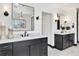 A stylish bathroom with dual vanities, framed mirrors and modern fixtures and finishes at 1100 S Gilpin St, Denver, CO 80210