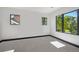 Bright bedroom with natural light, large windows, and carpeted floor. Modern minimal design at 1100 S Gilpin St, Denver, CO 80210
