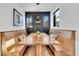 Cozy dining nook with built-in benches, wood table, decorative pillows, and stylish light fixture at 1100 S Gilpin St, Denver, CO 80210