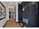 Hallway with decorative storage, bench seating, modern artwork, and hardwood flooring at 1100 S Gilpin St, Denver, CO 80210