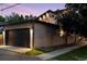 Home exterior showing an attached garage with a dark door and brick facade, blending style with functionality at 1100 S Gilpin St, Denver, CO 80210