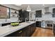 A kitchen featuring sleek countertops, modern appliances, floating shelves and hardwood floors at 1100 S Gilpin St, Denver, CO 80210