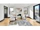 Cozy living room with white sofa, area rug, and plenty of natural light from windows with black trim at 1100 S Gilpin St, Denver, CO 80210