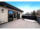 Brick patio with sleek wood decking and sliding glass doors leading to the home's interior at 1100 S Gilpin St, Denver, CO 80210