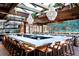 Interior of a restaurant featuring a bar with wood accents, pendant lighting, and comfortable seating at 1100 S Gilpin St, Denver, CO 80210