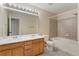 Bathroom featuring double sinks, tiled floors, and shower/tub combo at 12784 Jasmine St # E, Thornton, CO 80602