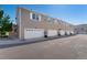 Townhome showcases attached garages, siding, and manicured landscaping at 12784 Jasmine St # E, Thornton, CO 80602