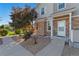 Inviting home exterior featuring stone accents, a well-kept lawn, and a welcoming front entrance at 12784 Jasmine St # E, Thornton, CO 80602