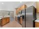 Spacious kitchen featuring stainless steel appliances, wood floors, and bright white countertops at 12784 Jasmine St # E, Thornton, CO 80602
