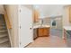 View of kitchen featuring stainless steel appliances, wood floors, and white countertops at 12784 Jasmine St # E, Thornton, CO 80602