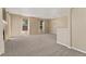 Bright and open living space with large windows, a chandelier, and neutral walls, ready for personal touches at 12784 Jasmine St # E, Thornton, CO 80602