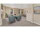 Open-concept living and dining area filled with natural light, featuring comfortable seating and stylish decor at 12784 Jasmine St # E, Thornton, CO 80602