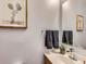 Contemporary half-bath features wood style vanity, framed mirror, decor, and modern fixtures at 6065 Wadsworth Blvd # A, Arvada, CO 80003