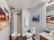 This bathroom includes a shower, toilet, vanity, and decor at 6065 Wadsworth Blvd # A, Arvada, CO 80003
