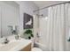 Bright bathroom with a white vanity, shower with curtain, and updated fixtures at 6065 Wadsworth Blvd # A, Arvada, CO 80003