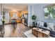 Open-concept living room and kitchen featuring stainless steel appliances, wood floors, and ample natural light at 6065 Wadsworth Blvd # A, Arvada, CO 80003