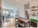 Open-concept living and dining area with stylish furniture, wood floors, and plenty of natural light at 6065 Wadsworth Blvd # A, Arvada, CO 80003