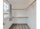Functional walk-in closet with ample shelving and natural light from the window at 6065 Wadsworth Blvd # A, Arvada, CO 80003