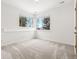 Bright bedroom with neutral carpet, white walls, and bright double windows at 1580 Santa Fe Mountain Rd, Evergreen, CO 80439