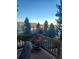 Scenic deck view overlooking lush greenery and distant mountains, perfect for relaxing outdoors at 1580 Santa Fe Mountain Rd, Evergreen, CO 80439